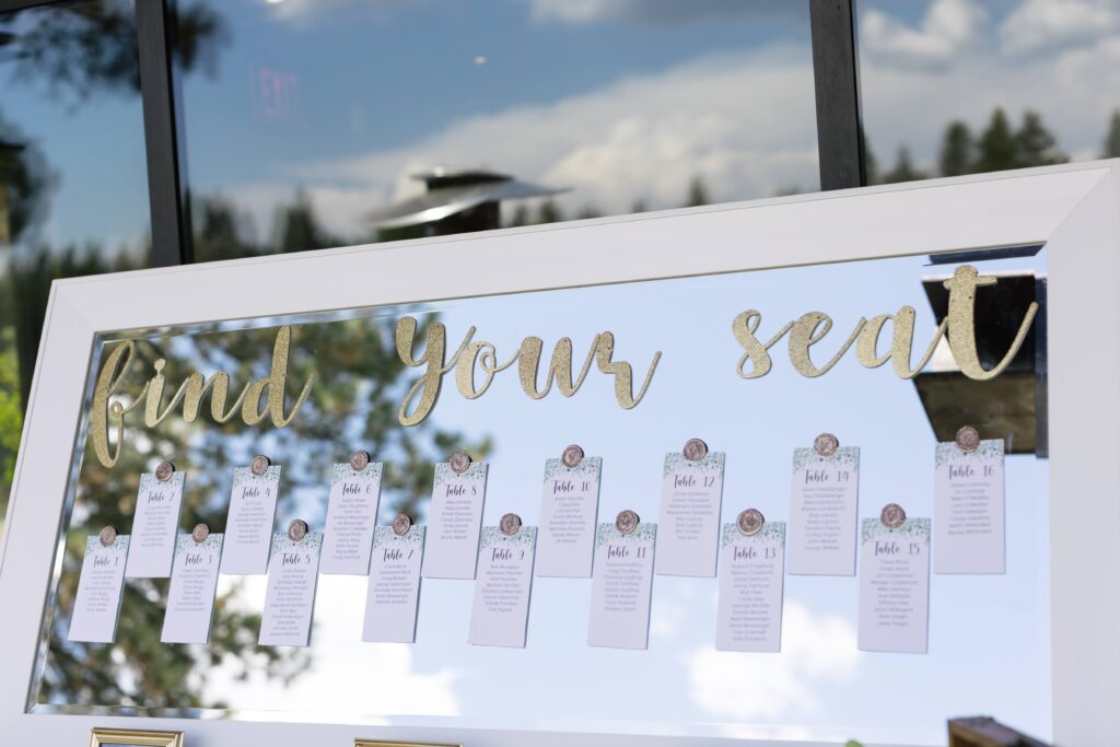 Mirror reading "find your seat" with sixteen paper lists attached.