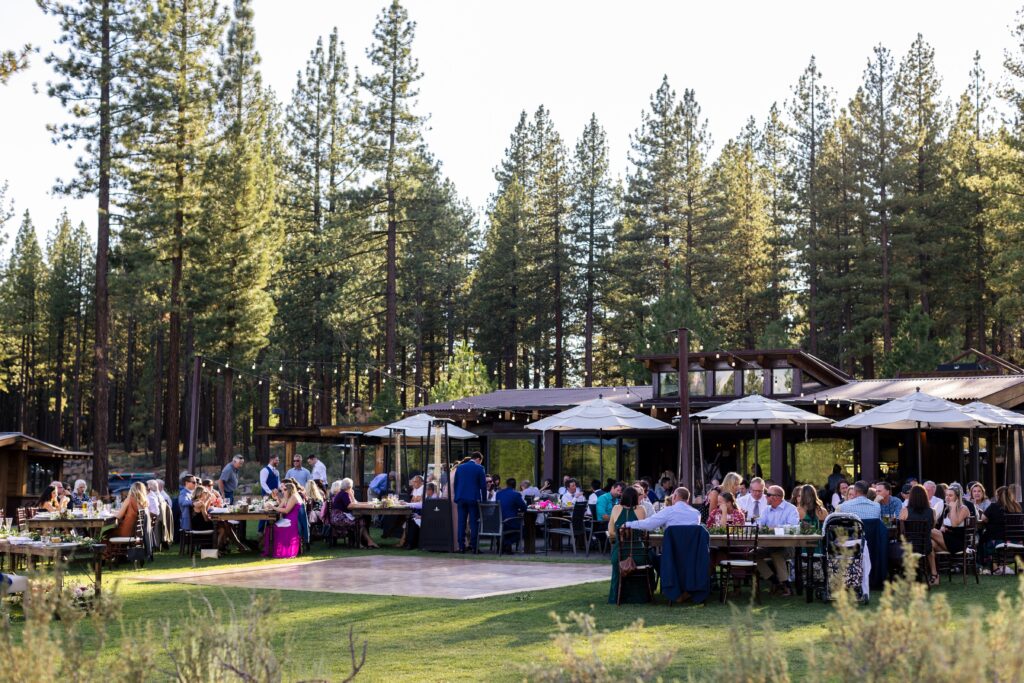 Wedding dinner reception venue amongst pine trees.