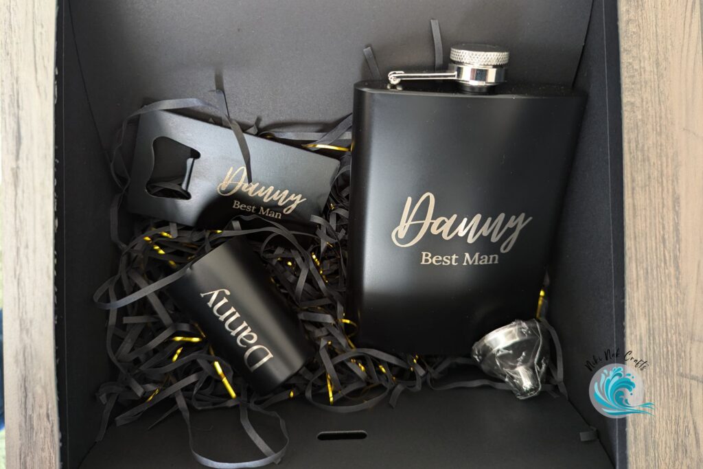 Three personalized black metal drink ware items including a flask, bottle opener and shot glass, each reading "Danny Best Man".