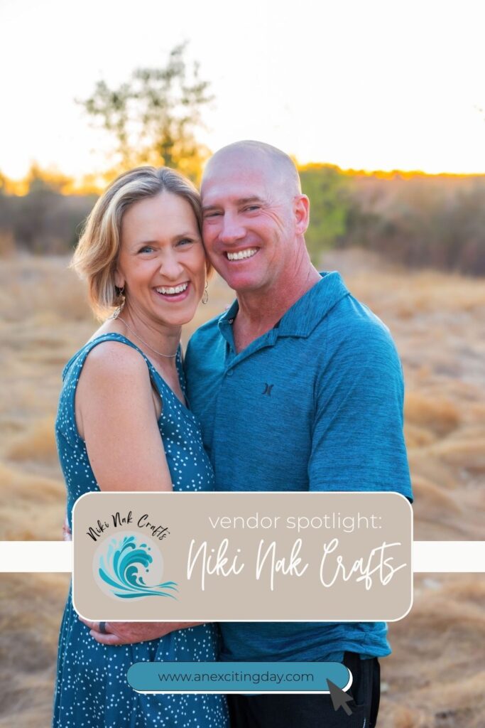 One woman and one man smiling in an embrace outside at golden hour, both wearing shades of blue with overlay text reading "vendor spotlight Niki Nak Crafts".